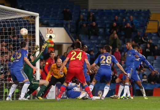 07.03.2013 Bucharest Romania..FC Steaua Bucuresti versus Chelsea Europa  League Football knock-out stages 1/8 finals. John Terry wins a powerful  header with John Obi Mikel Chelsea between Raul Rusescu(L) and Leandro Tatu  (r)